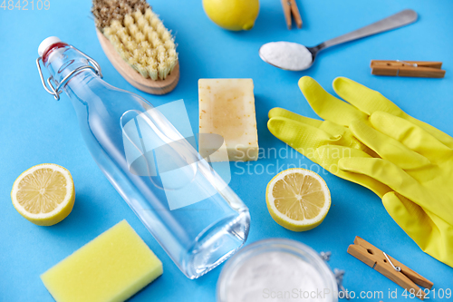 Image of vinegar, lemons, washing soda, gloves and brush