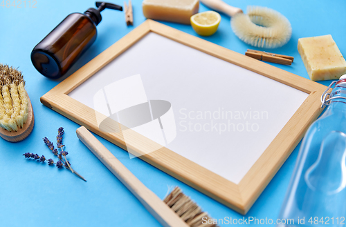 Image of natural cleaning supplies around white board