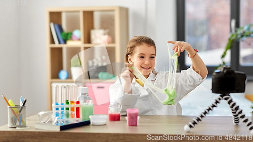 Image of girl with slime and camera video blogging at home