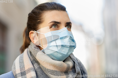 Image of young woman wearing protective medical mask