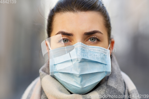 Image of young woman wearing protective medical mask