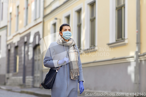 Image of young woman wearing protective medical mask