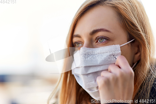 Image of young woman wearing protective medical mask