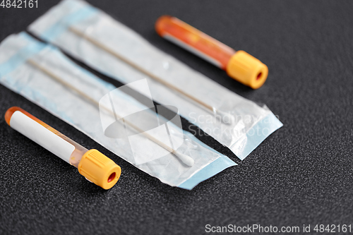 Image of test tubes with blood plasma and cotton swabs