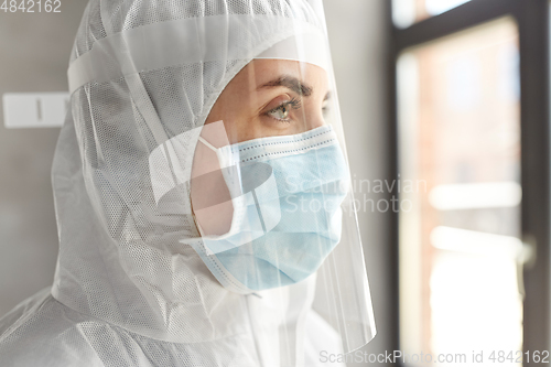 Image of doctor in protective wear, mask and face shield