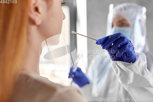 Image of doctor in protective wear making coronavirus test