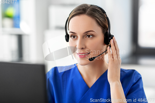 Image of doctor with headset and computer at hospital