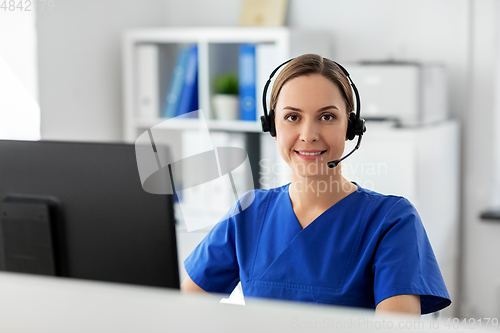 Image of doctor with headset and computer at hospital