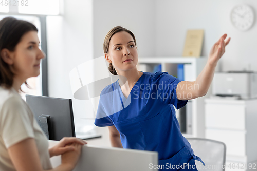 Image of doctor showing something to patient at hospital