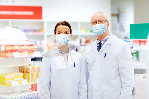 Image of apothecaries wearing medical masks at pharmacy