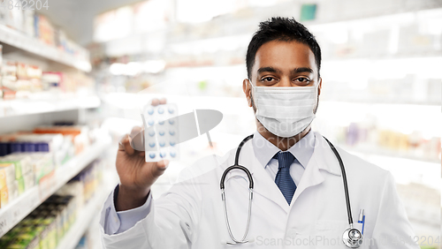 Image of indian male doctor or pharmacist in mask with drug