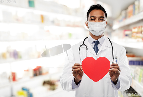 Image of indian male doctor in mask with red heart shape