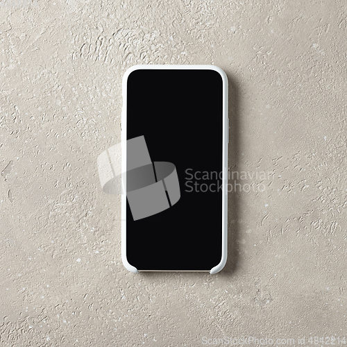 Image of smartphone on beige color table top