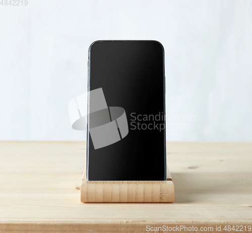 Image of smartphone on light wooden table