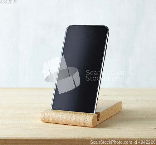 Image of smartphone on light wooden table