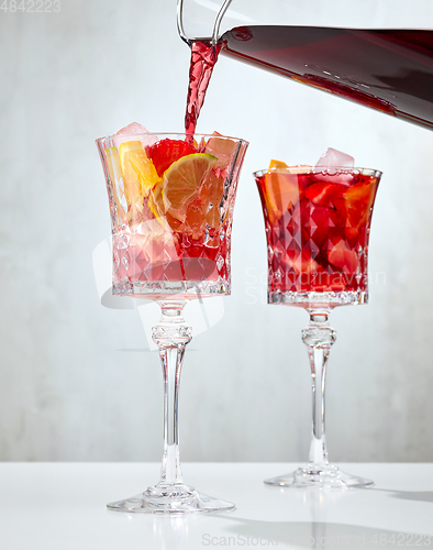 Image of red wine pouring into glass