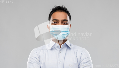 Image of indian businessman in mask over grey background