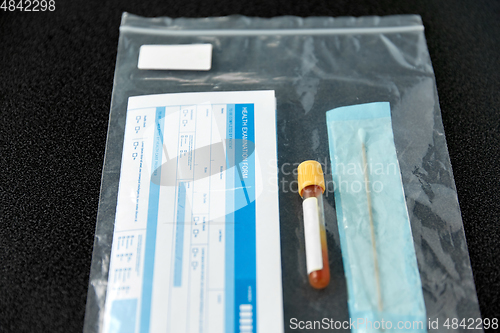 Image of beaker with test, cotton swab and medical report