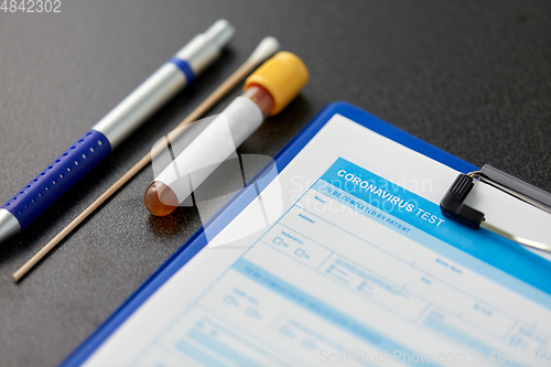 Image of medical report, test tube, cotton swab and pen