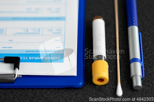 Image of medical report, test tube, cotton swab and pen