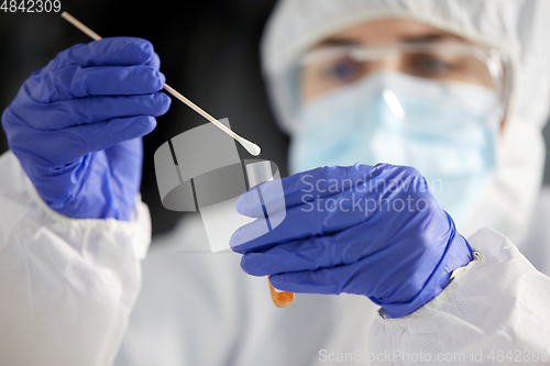 Image of scientist holding beaker with coronavirus test