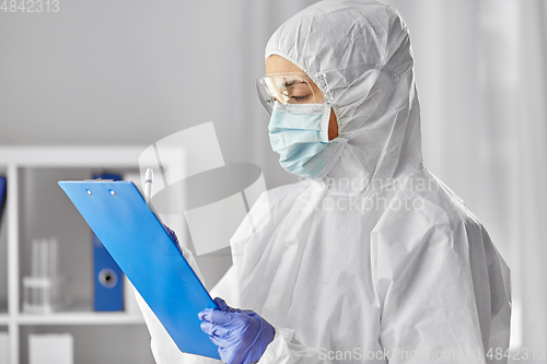 Image of doctor in medical mask and goggles with clipboard