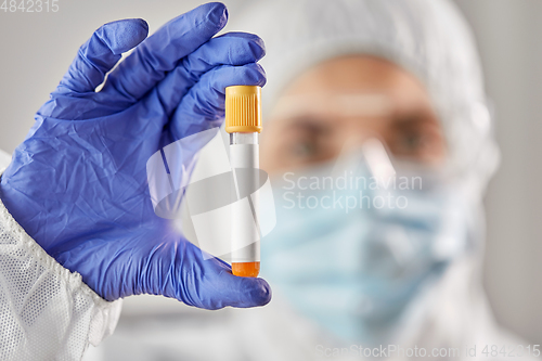 Image of scientist in protective mask with test tube