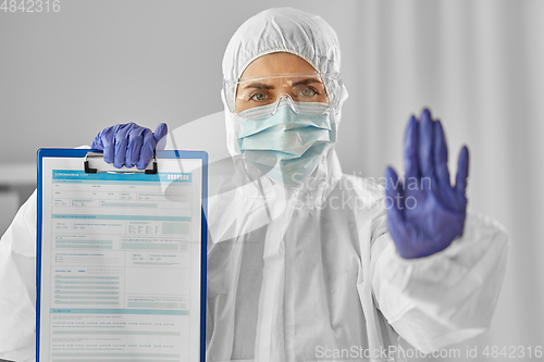 Image of doctor in medical mask and goggles with clipboard