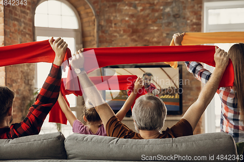 Image of Excited, happy big family team watch sport match together on the couch at home