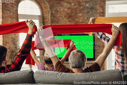 Image of Excited, happy big family team watch sport match together on the couch at home