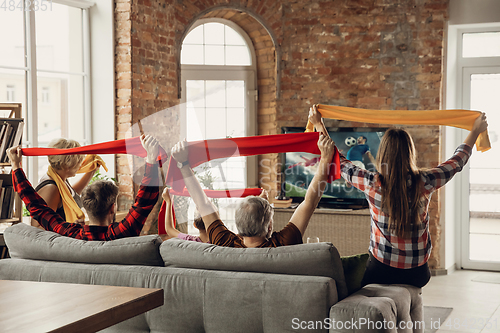 Image of Excited, happy big family team watch sport match together on the couch at home