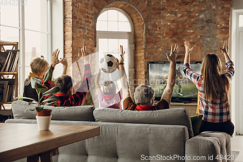 Image of Excited, happy big family team watch sport match together on the couch at home