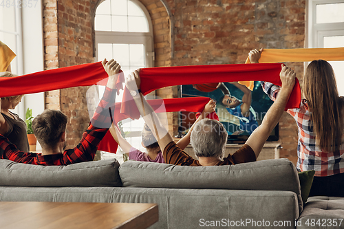 Image of Excited, happy big family team watch sport match together on the couch at home