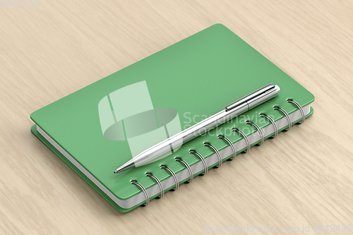 Image of Green notebook and silver pen