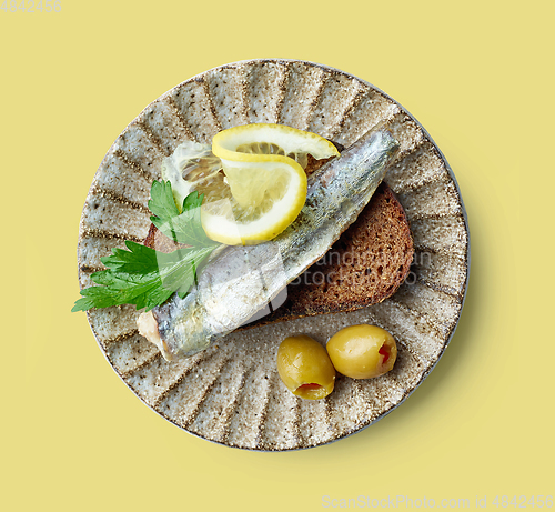 Image of canned sardine on bread slice