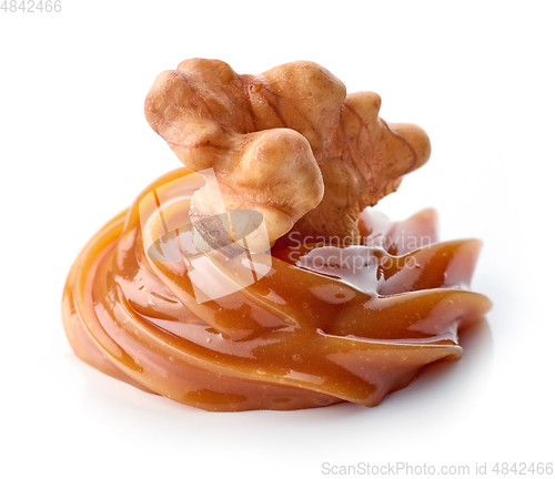 Image of walnut in melted caramel