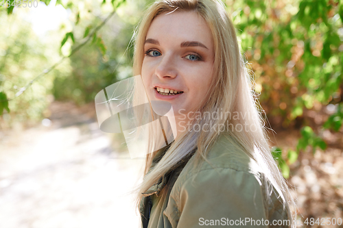 Image of Young adult woman spending quality time in the forest