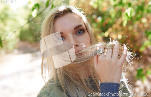 Image of Young adult woman spending quality time in the forest