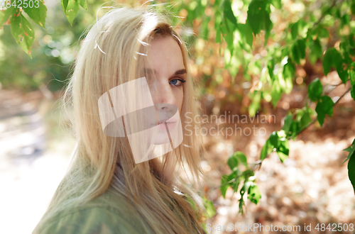 Image of Young adult woman spending quality time in the forest