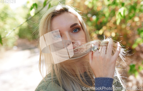 Image of Young adult woman spending quality time in the forest