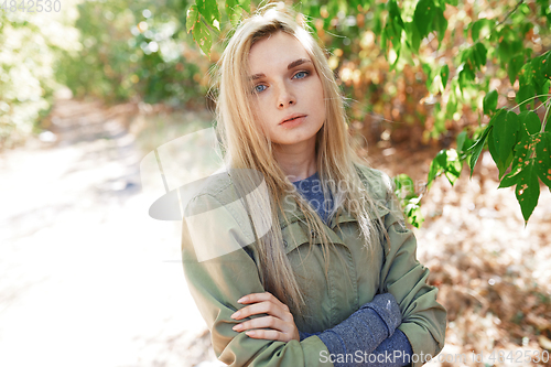 Image of Young adult woman spending quality time in the forest