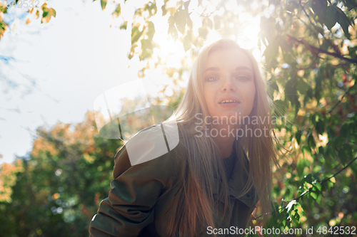 Image of Young adult woman spending quality time in the forest