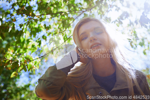 Image of Young adult woman spending quality time in the forest