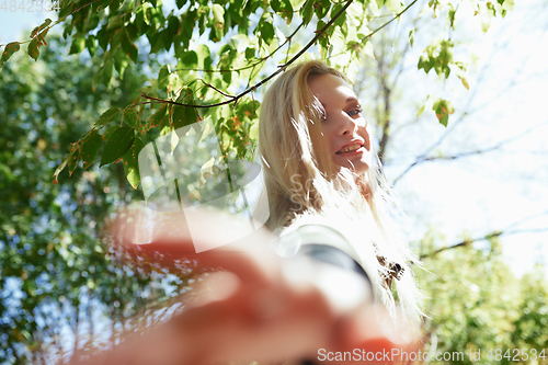 Image of Young adult woman spending quality time in the forest