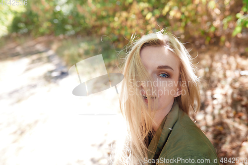 Image of Young adult woman spending quality time in the forest