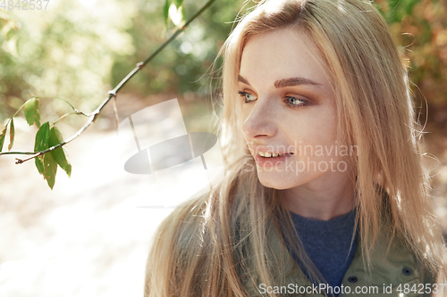 Image of Young adult woman spending quality time in the forest