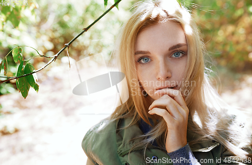 Image of Young adult woman spending quality time in the forest