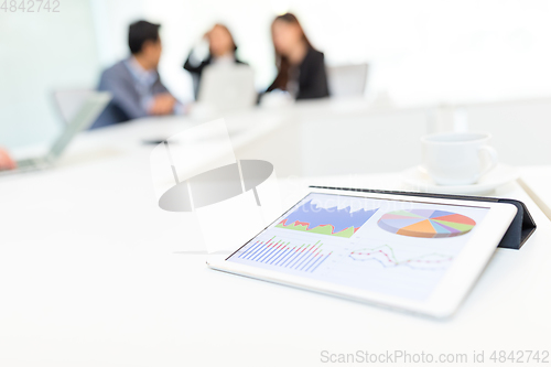 Image of Digital tablet showing data chart on screen at business meeting 