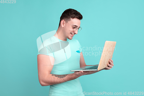 Image of Caucasian young man\'s portrait on blue studio background