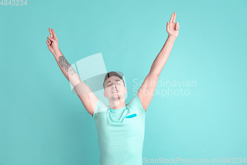 Image of Caucasian young man\'s portrait on blue studio background